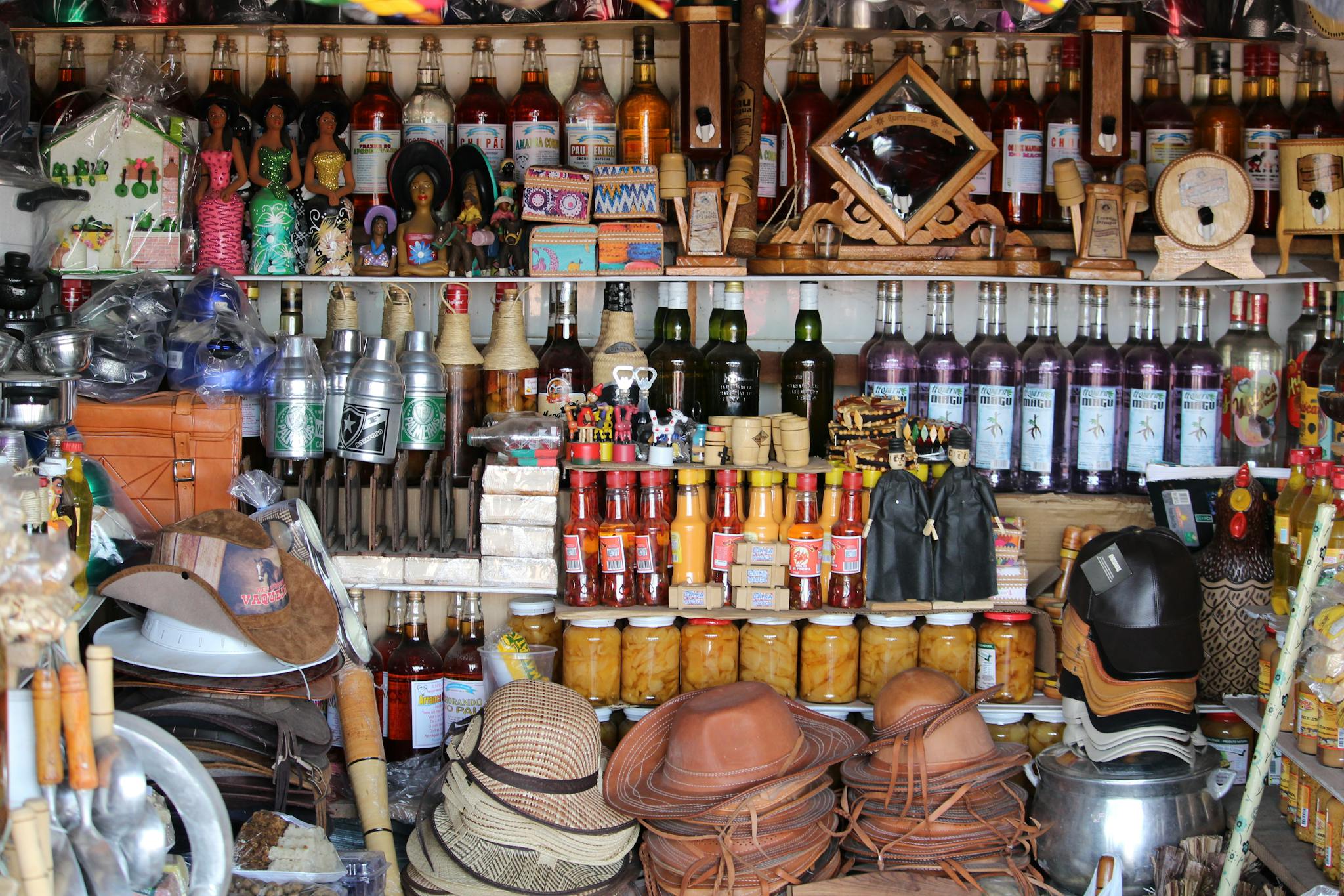 Vibrant market stand in Tianguá, Brazil showcasing local crafts and bottles.